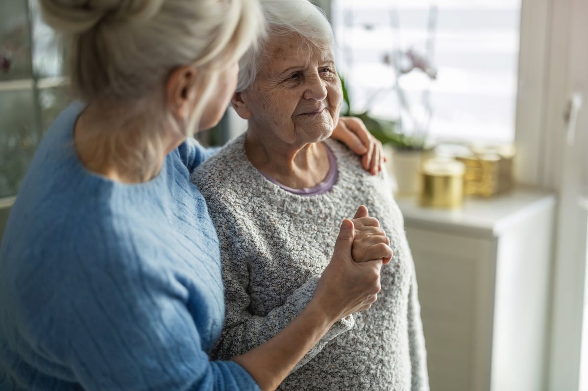 Elderly African American woman with her caregiver in a nursing home